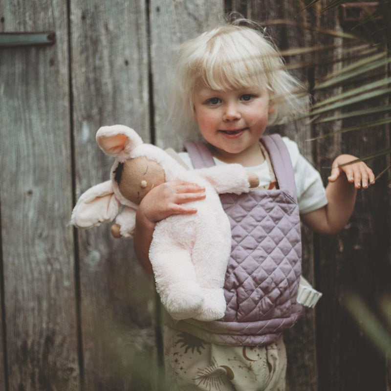 A qulited lavender Olli Ella Doll Carrier with padded straps designed for carrying dolls.